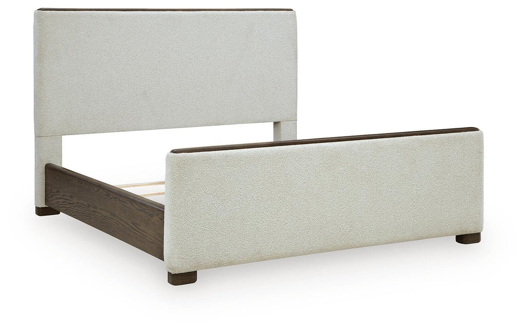 Radkin Queen Upholstered Panel Bed in Burnished Brown, angle view