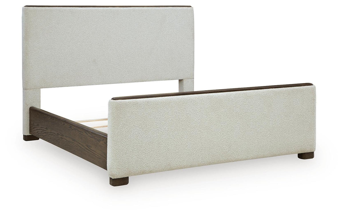 Radkin Queen Upholstered Panel Bed in Burnished Brown, angle view
