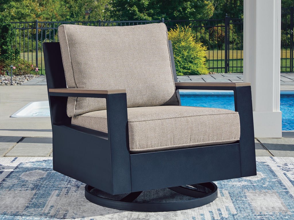 East Beach Outdoor Swivel Glider Chair with Cushion in Navy Blue/Driftwood, lifestyle view