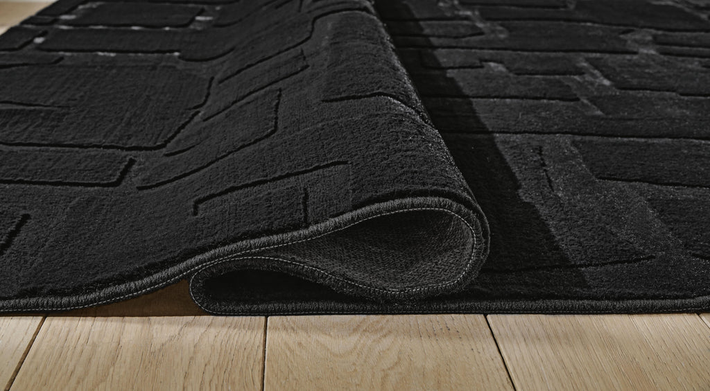 Gibbswell Washable 5' x 7' Area Rug in Black, detail view