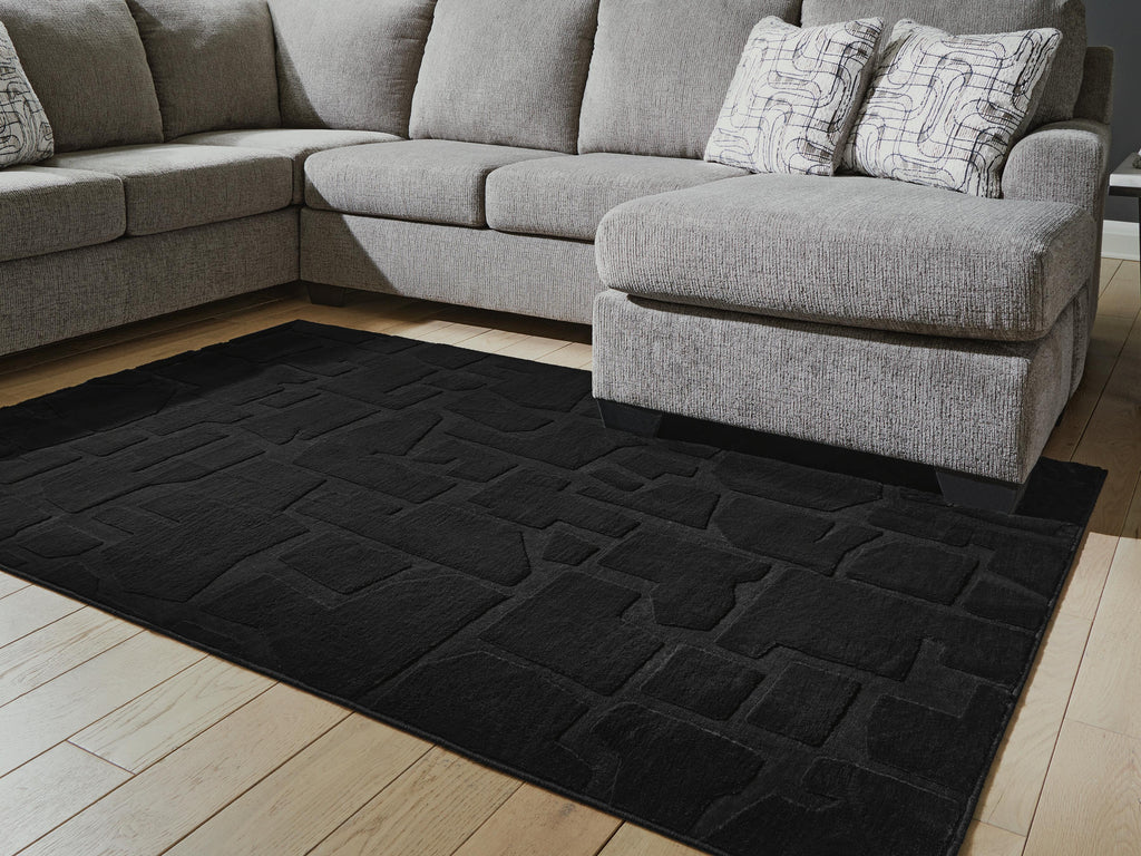 Gibbswell Washable 5' x 7' Area Rug in Black, lifestyle view