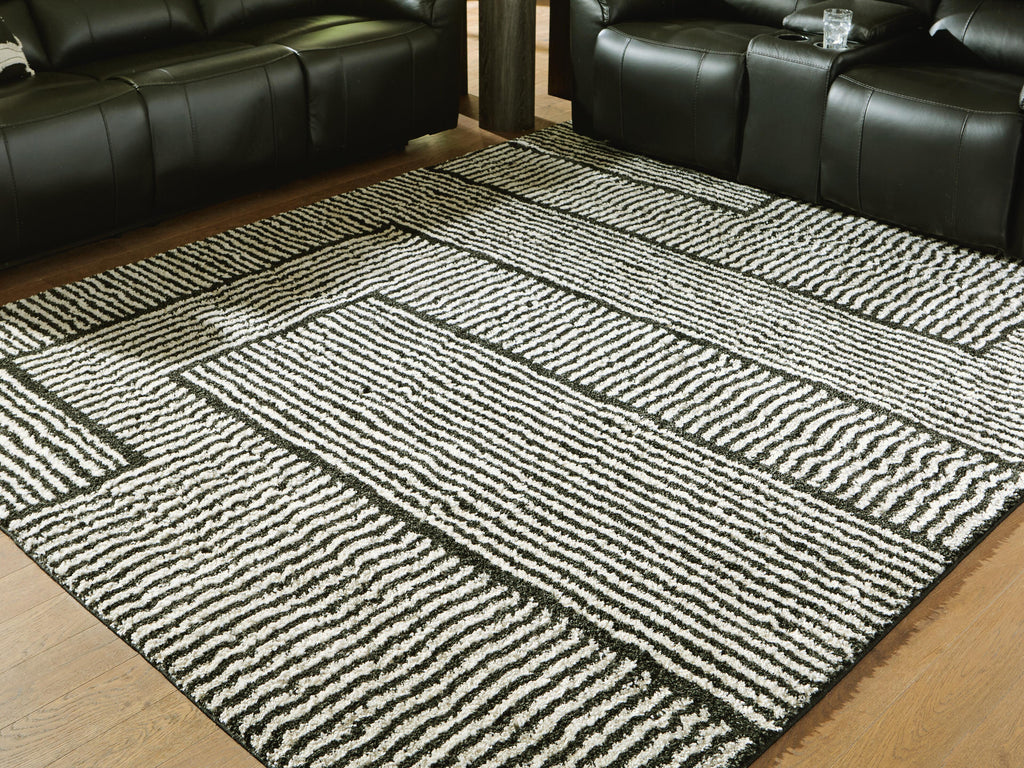 Kurtmen 7'10" x 9'10" Area Rug in Black/Ivory, lifestyle view