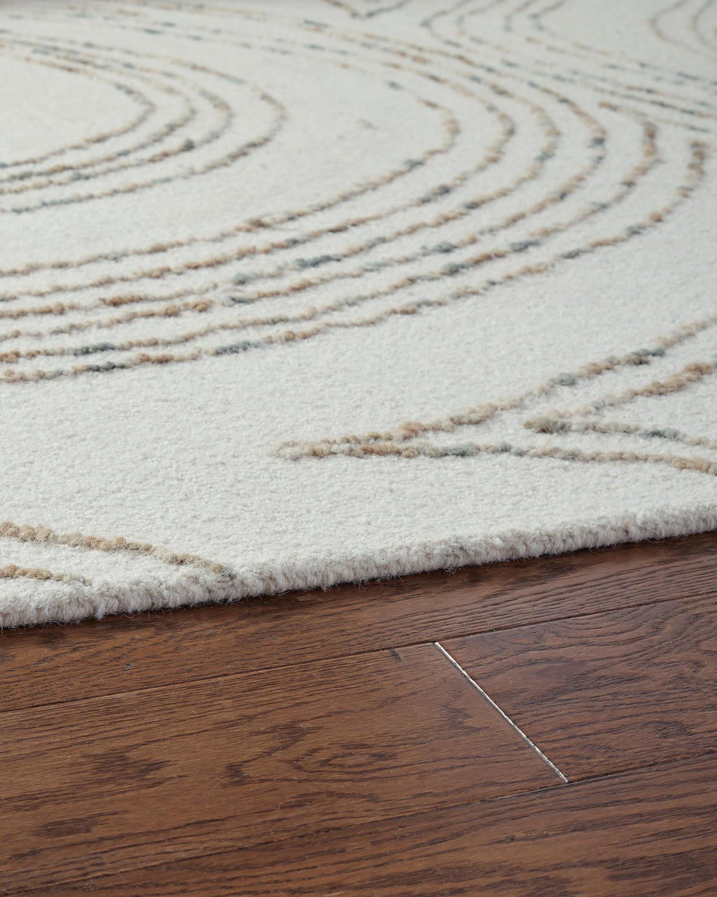 Deenbury 5' x 7' Area Rug in Ivory/Green/Brown, detail view