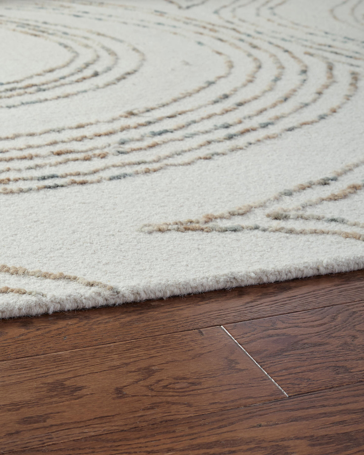 Deenbury 5' x 7' Area Rug in Ivory/Green/Brown, detail view